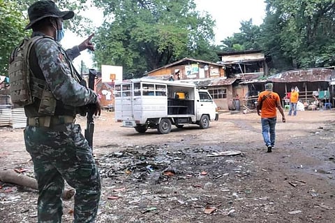 ARMED FRONTLINER. A Special Action Force (SAF) trooper patrols the interior portion of Barangay Guadalupe, Cebu City on Monday, Aug. 3, 2020. The presence of 150 SAF troopers in Cebu City (now placed on general community quarantine) will be no more by Aug. 15 after Camp Crame pulled them out and reassigned them to the National Capital Region, which is now on modified enhanced community quarantine. The police officers, including SAF troopers, are non-medical frontliners in the fight to contain the spread of the coronavirus disease 2019—they enforce quarantine restrictions and arrest violators of health protocols such as those who do not wear masks in public. (Photo by Amper Campaña)