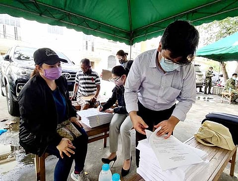 ANOTHER LIBEL CASE. Lawyers Jose Mari Lacas (right) and Camille Mendoza (center) go through the complaint sheet of Real Steel Corporation  represented by HR head Jenalyn Salazar (left), which was filed on Friday, September 25, 2020, before the Provincial Prosecutor's Office of Pampanga. (Photo Chris Navarro)