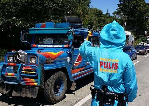 BORDER CONTROL. Cops check travel requirements of residents from La Trinidad, Tublay, Tuba and Sablan going to Baguio City following the travel restrictions imposed by Mayor Benjamin Magalong. (Jean Nicole Cortes)