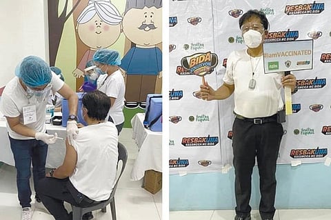 JABBED. Minglanilla, Cebu Mayor Elanito Peña (left) receives a jab of Covid-19 AstraZeneca vaccine during the first day of the Rural Health Unit's vaccination on Tuesday, March 23, 2021. After his inoculation, Peña (right) had his photo taken for posterity, announcing that he already received the vaccine. The local executive said he had himself inoculated as he considered himself a "frontliner" in the fight against Covid-19. (MINGLANILLA MUNICIPAL GOVERNMENT)