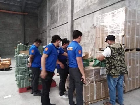 PAMPANGA. CIDG agents inspect boxes of suspected counterfeit cigarettes and raw materials discovered in Mabalacat City and San Simon town on June 24, 2021. (PRO-Central Luzon) 