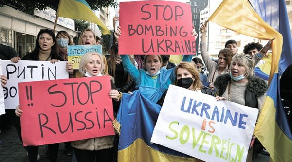 PROTEST. Ukrainians who live in Lebanon hold placards and chant slogans during a protest against Moscow's wide-ranging attack on their country, outside the Russian embassy in Beirut, Lebanon, Thursday, Feb. 24, 2022. / AP