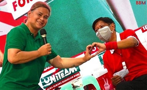 Vice President Sara Duterte and President Ferdinand “Bongbong” Marcos are seen making a heart hand gesture during a political campaign in 2022.