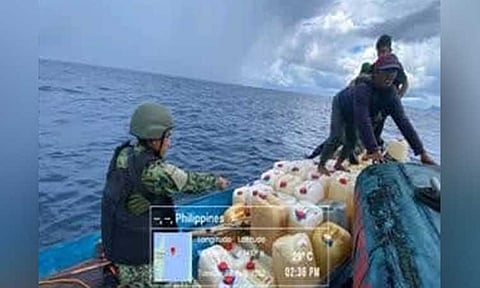 ZAMBOANGA. Policemen conducting seaborne patrol intercept and seize some P64,200 worth of smuggled gasoline on Tuesday, August 2, off Sitangkai, Tawi-Tawi. A photo handout shows a policeman inspecting the fishing boat they intercepted loaded with containers of smuggled gasoline. (SunStar Zamboanga)
