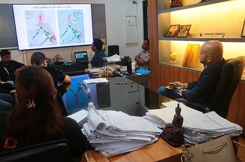MEETING. Barili Mayor Pablo John IV (right) holds a meeting about the African swine fever in his office. The mayor issued a memorandum that temporarily bans the trading of pigs at the Mantalongon Livestock Market, the biggest livestock market in Cebu Province. / CONTRIBUTED 