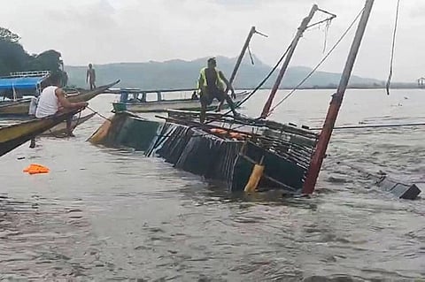 RIZAL. In this image from video provided by the Philippine Coast Guard, a man stands on a capsized passenger boat as they undergo rescue operations at Binangonan, Rizal province, east of Manila, Philippines on Thursday, July 27, 2023. (AP)