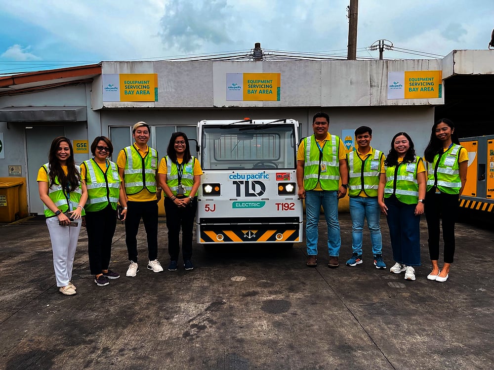 DEMO RUN. Members of the Cebu Pacific team during the demonstration run of the electric baggage tractor and charging station technology.