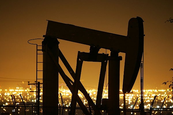 Pumps draw petroleum from oil wells through the night. (David McNew/Getty Images)