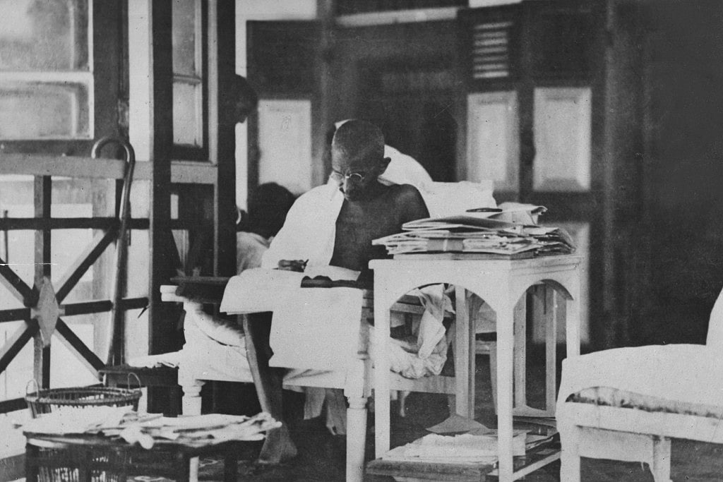 Mahatma Gandhi  reading his correspondance whilst living in seclusion after being released from prison. (Topical Press Agency/Getty Images)