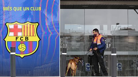 A security guard enters the offices of Barcelona Football Club with a dog on March 01, 2021 in Barcelona during a police operation inside the building. 
