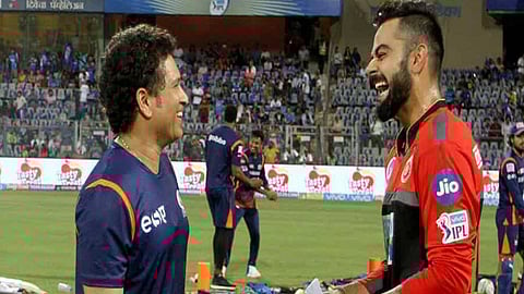 Sachin Tendulkar and Virat Kohli share a light moment during IPL 2018