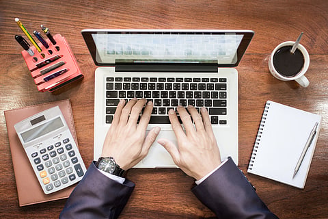 Top view of business man hands working on laptop or tablet pc on