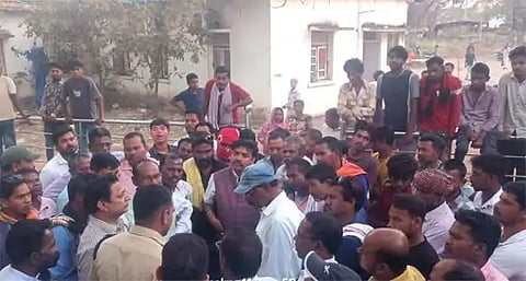 Discussing with community officials and villagers during the protest
