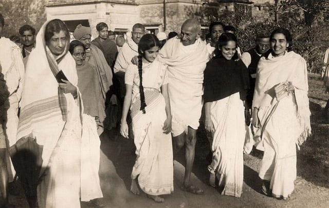 Young Nirmala with Mahatma Gandhi (to his right)