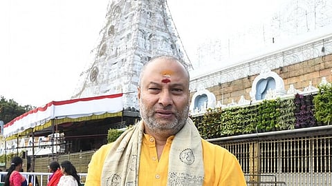 TTDP Board Member and BJP leader Bhanu Prakash Reddy standing in front of a temple