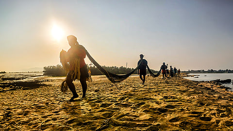 Fishers carrying shore seine nets (kambavala) at the Poonthura coast