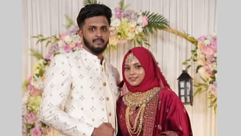 hahana and Abdul Vahid posing together in wedding attire, surrounded by floral decorations. 