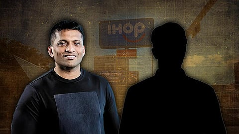 A digitally edited image featuring Byju Raveendran in a black shirt smiling, with a blurred IHOP restaurant sign in the background. Beside him is a silhouette of an unidentified person, creating a sense of mystery. The background has a dark, investigative tone.