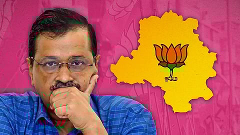 Arvind Kejriwal with a map of Delhi with a lotus symbol.