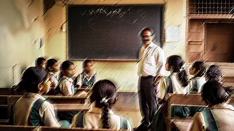 A male teacher in a classroom, facing a class of female students.