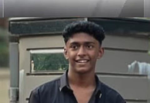 Image of Mohammed Shahabas wearing black shirt smiling in front of a metallic structure