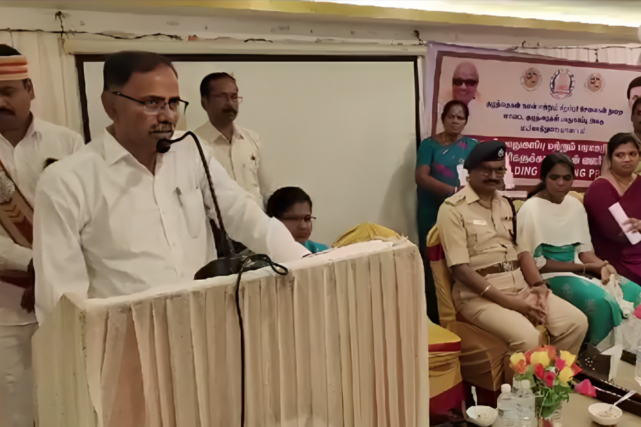 Mayiladuthurai collector AP Mahabharathi, in a white shirt, speaking from behind a podium at a POCSO Act awareness programme.