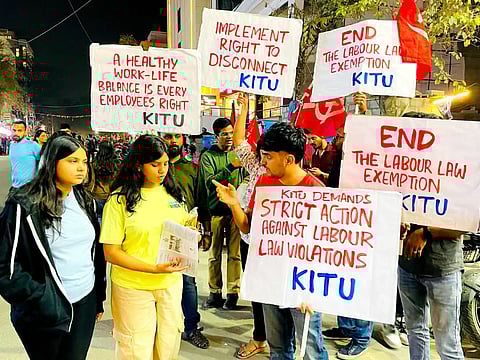 A group of youngsters holding red flags and placards campaigning on the streets