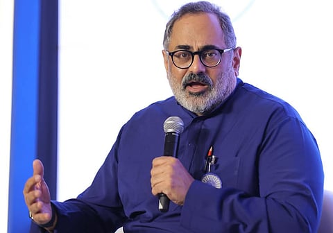 Rajeev Chandrasekhar in a blue shirt speaking via mic