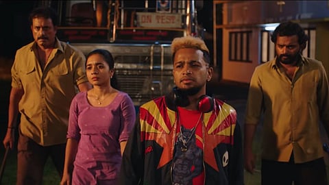 A scene from the film Maranamass, with four characters standing in a row, as though ready for a fight. 