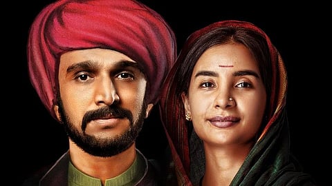 A picture of Jyotirao and Savitribhai from the film 'Phule'. The background is black and the picture has an oil painting like quality