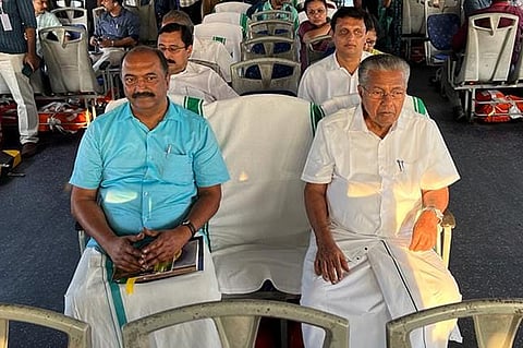 Kerala Finance Minister KN Balagopal and Chief Minister Pinarayi Vijayan are seen seated together on what appears to be a boat. Other ministers can be seen in the rows behind them
