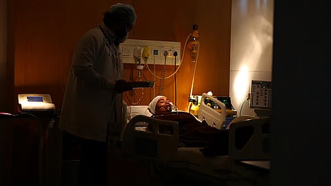 A doctor and patient in a hospital room