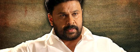 Malayalam actor Dileep in a cream shirt, looking sombre, looking slightly to the left of the camera