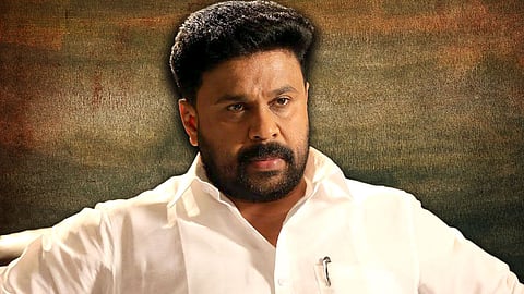 Malayalam actor Dileep in a cream shirt, looking sombre, looking slightly to the left of the camera