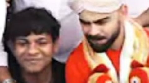 Chief Minister Siddaramaiah’s grandson Dhawan Rakesh with Virat Kohli