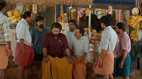 Image from the film showing men gathered in front of a local grocery store.