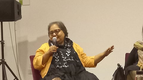 Paromita Vohra seated on the dias, speaking through a mic.