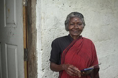 Sarassu, a 69 year old daily wage labourer in Pullampara, with her smartphone