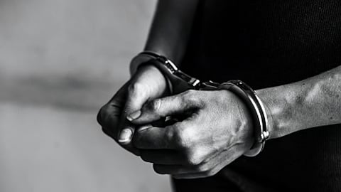 Representative image showing a person in handcuffs