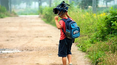 A school going child in the road alone