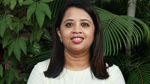 Image featuring Dhanya Rajendran wearing a white dress 