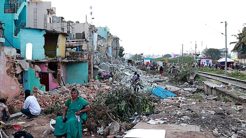 Displaced residents sit amid the rubble of their demolished homes near KG Halli Railway Gate in Bengaluru.