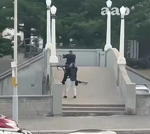 Footage shows the two gunmen beginning their attack from the bridge.