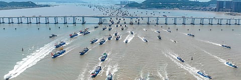 Fishing boats leave Zhoushan, China, on Aug. 1, 2024. Many ships like these stay at sea for months, often far from home. 