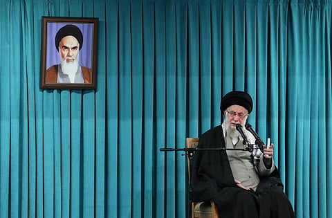 In this photo released by the official website of the office of the Iranian supreme leader, Supreme Leader Ayatollah Ali Khamenei speaks under a portrait of the late revolutionary founder Ayatollah Khomeini, in a ceremony meeting a group of officials, in Tehran, Iran, March 8, 2025. 