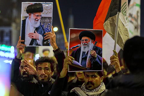 Iraqi Shiites hold pictures of Iranian Supreme Leader Ayatollah Ali Khamenei, who was killed by a U.S. airstrike in Tehran, during a symbolic funeral, in Najaf, Iraq, Sunday, March 1, 2026. 