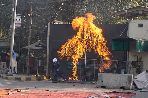Shiite Muslims set a fire at the U.S. Consulate's entrance gate during a rally to condemn the killing of Iranian Supreme Leader Ayatollah Ali Khamenei, in Lahore, Pakistan, Sunday, March 1, 2026. 