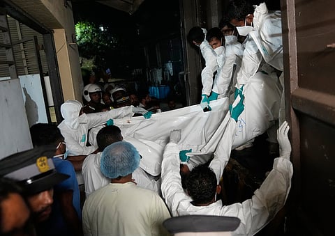 Healthcare workers unload from a vehicle, the bodies of Iranian sailors who died when their IRIS Dena warship sank outside Sri Lanka's territorial waters, in Galle, Sri Lanka, Wednesday, March 4, 2026. 