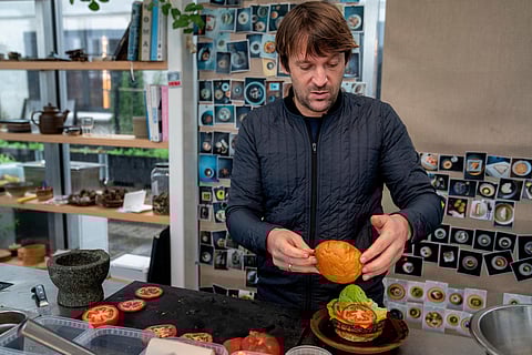 Noma's chef René Redzepi prepares a vegetarian burger in a restaurant, in Copenhagen, Nov. 24, 2024. 