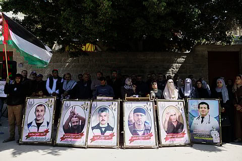 Relatives of Palestinian prisoners held in Israeli jails demonstrated against the decision by Israel's parliament to approve the death penalty for Palestinians convicted of murdering Israelis in front of the Red Cross headquarters in Gaza City, Tuesday, March 31, 2026. 